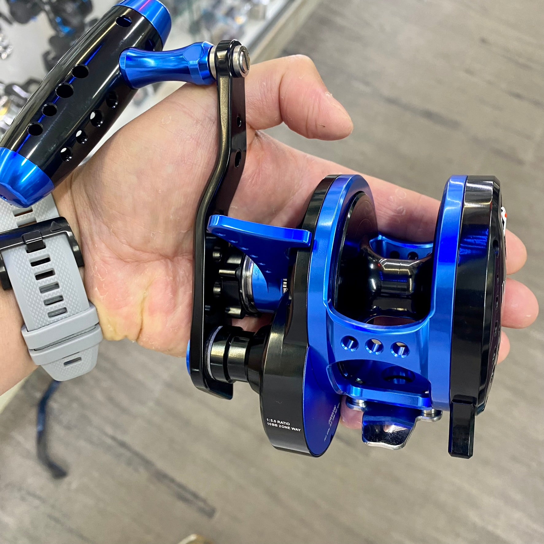 Wiki Jigging Devil Star 3000H Black Blue Overhead Lever Drag Reel in someones hand