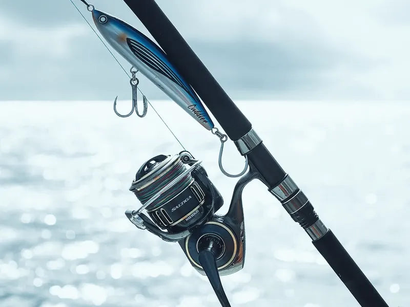 Rod and reel combo with a lure over the water